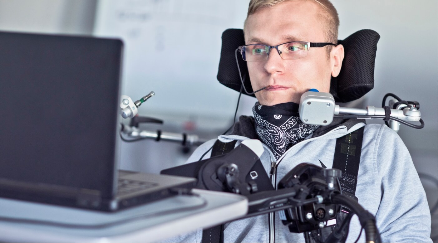 person in wheelchair using assistive technology