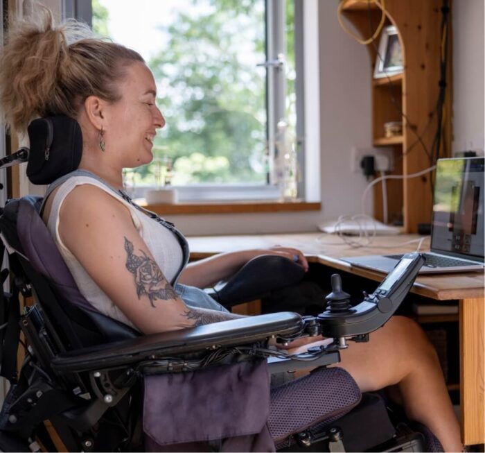 woman in wheelchair working on laptop