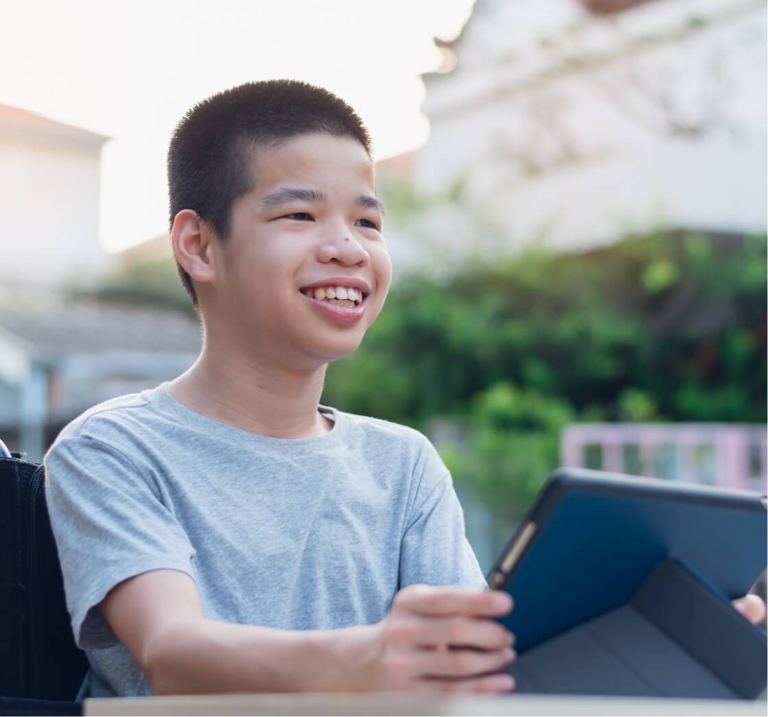 boy tilting tablet device